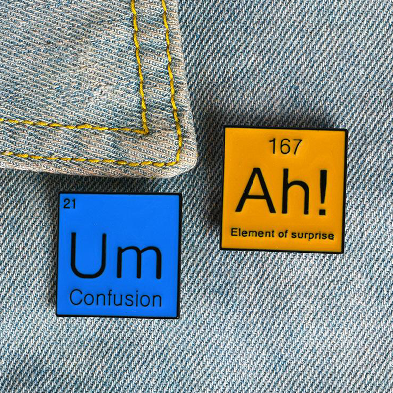 Two periodic pins. The element of surprise (Ah!) and the element of confusion (Um).